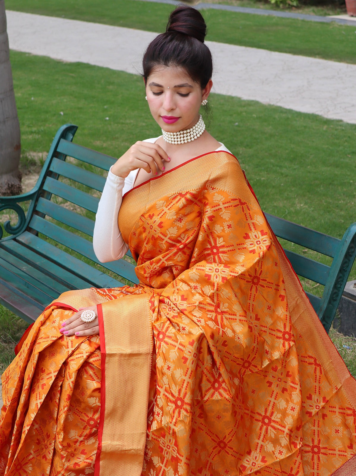 Bandhej silk saree having gold zari border and tassels to pallu with contrast pallu andblouse.